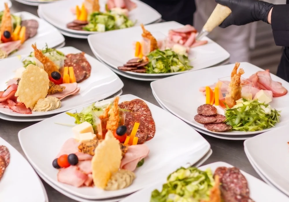 Professional private chefs plating gourmet appetizers for a luxury corporate event and private catering service in Dubai, UAE.